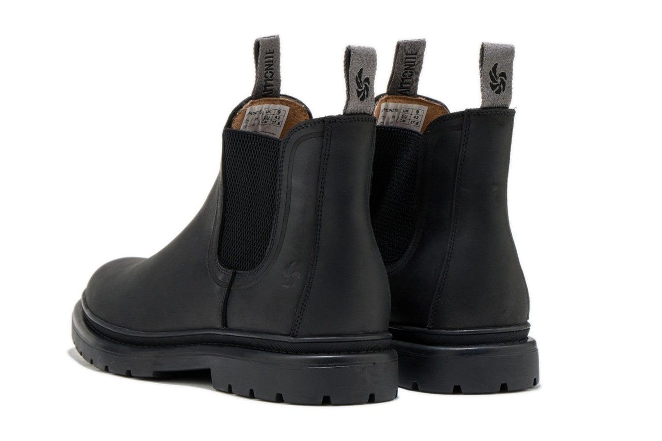 Men’s black outdoor chelsea boots, slightly angled back view showcasing pull tabs and on a white background.