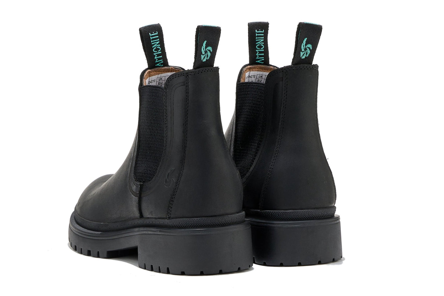 Women’s black outdoor chelsea boots, slightly angled back view showcasing pull tabs and on a white background.