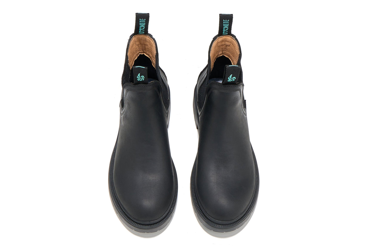 Women’s black outdoor chelsea boots, top-down view showing sleek design and shape on a white background.