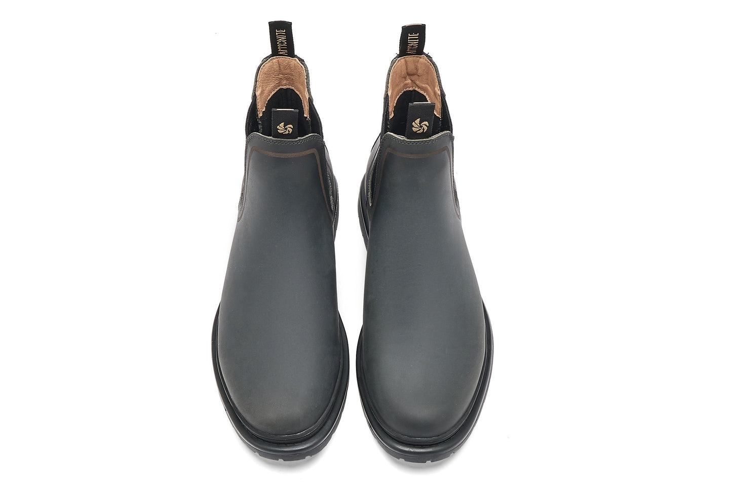 Top view of dark grey chelsea boots on a white background