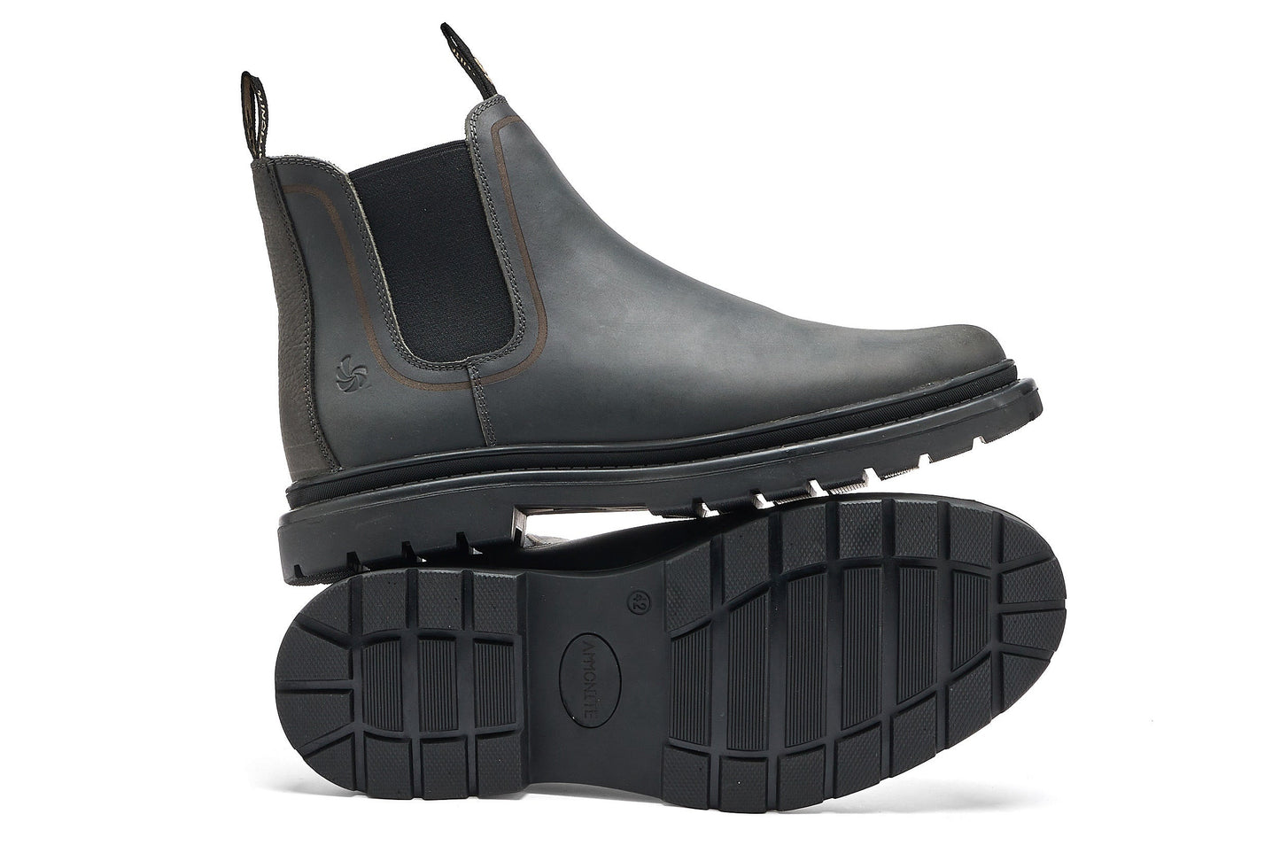 Pair of dark grey chelsea boots on a white background