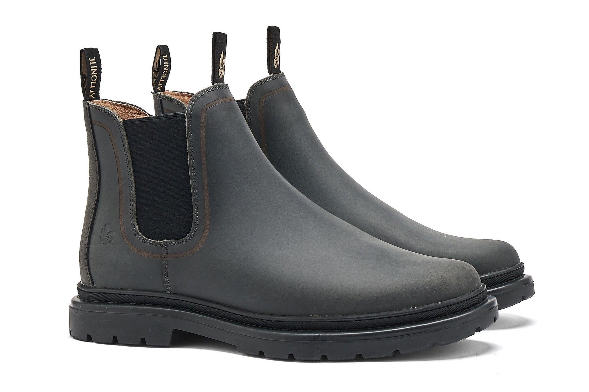 Pair of dark grey chelsea boots on a white background