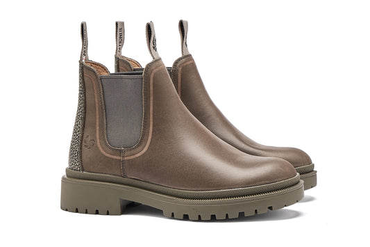 Pair of grey Chelsea boots on a white background