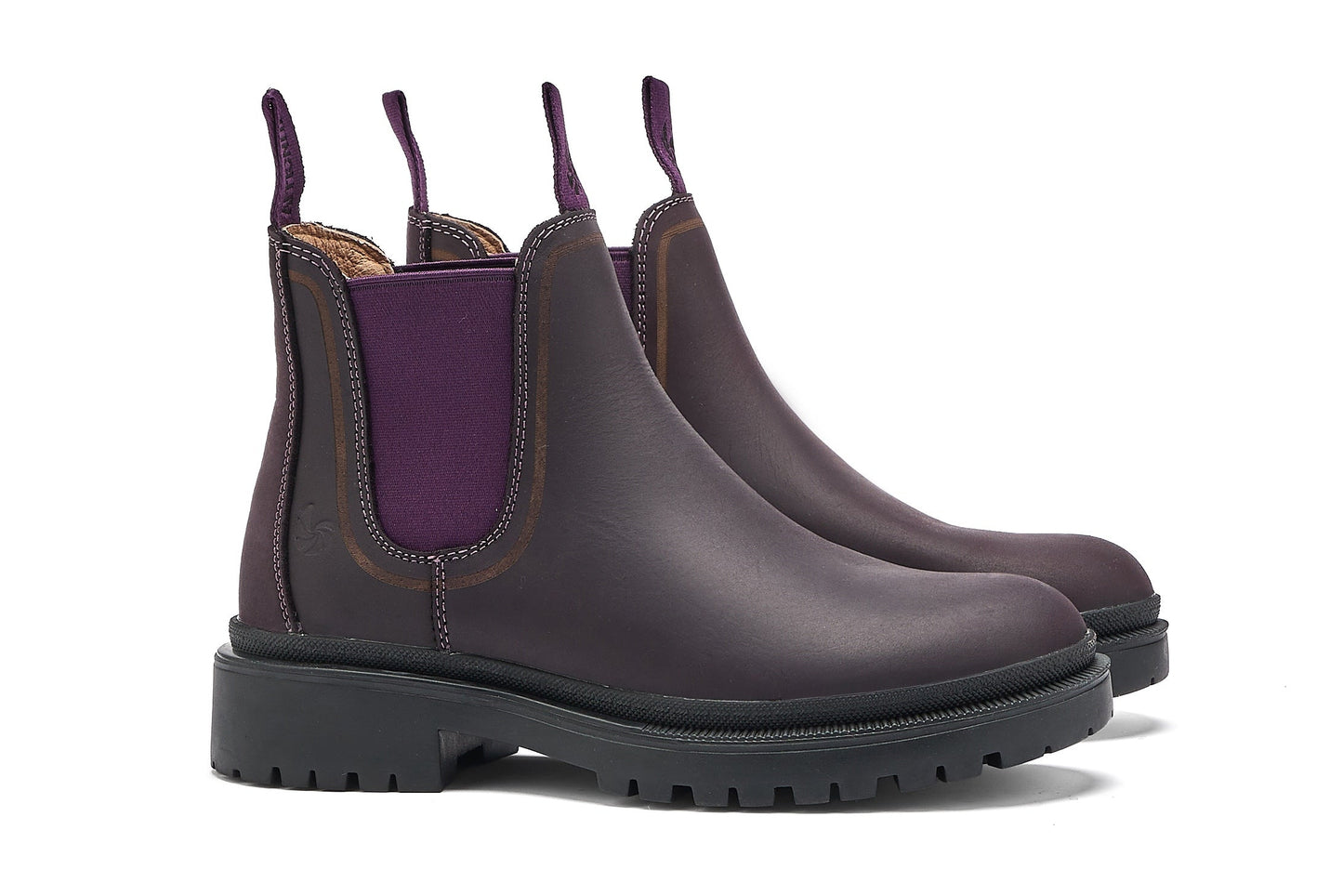 Pair of dark purple chelsea boots with a white background