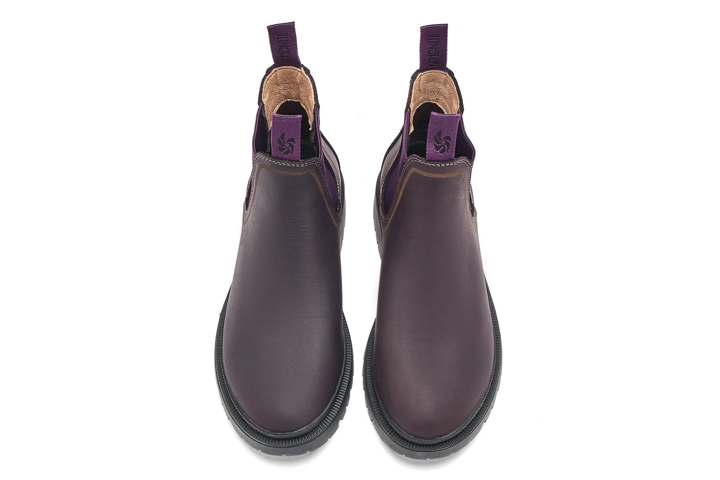 Pair of purple Chelsea boots on a white background