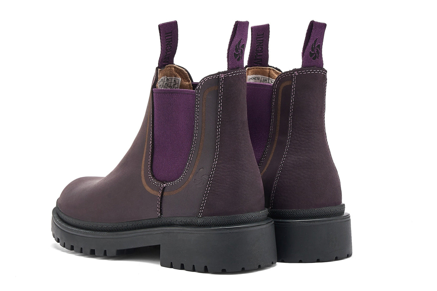 Pair of dark purple Chelsea boots on a white background